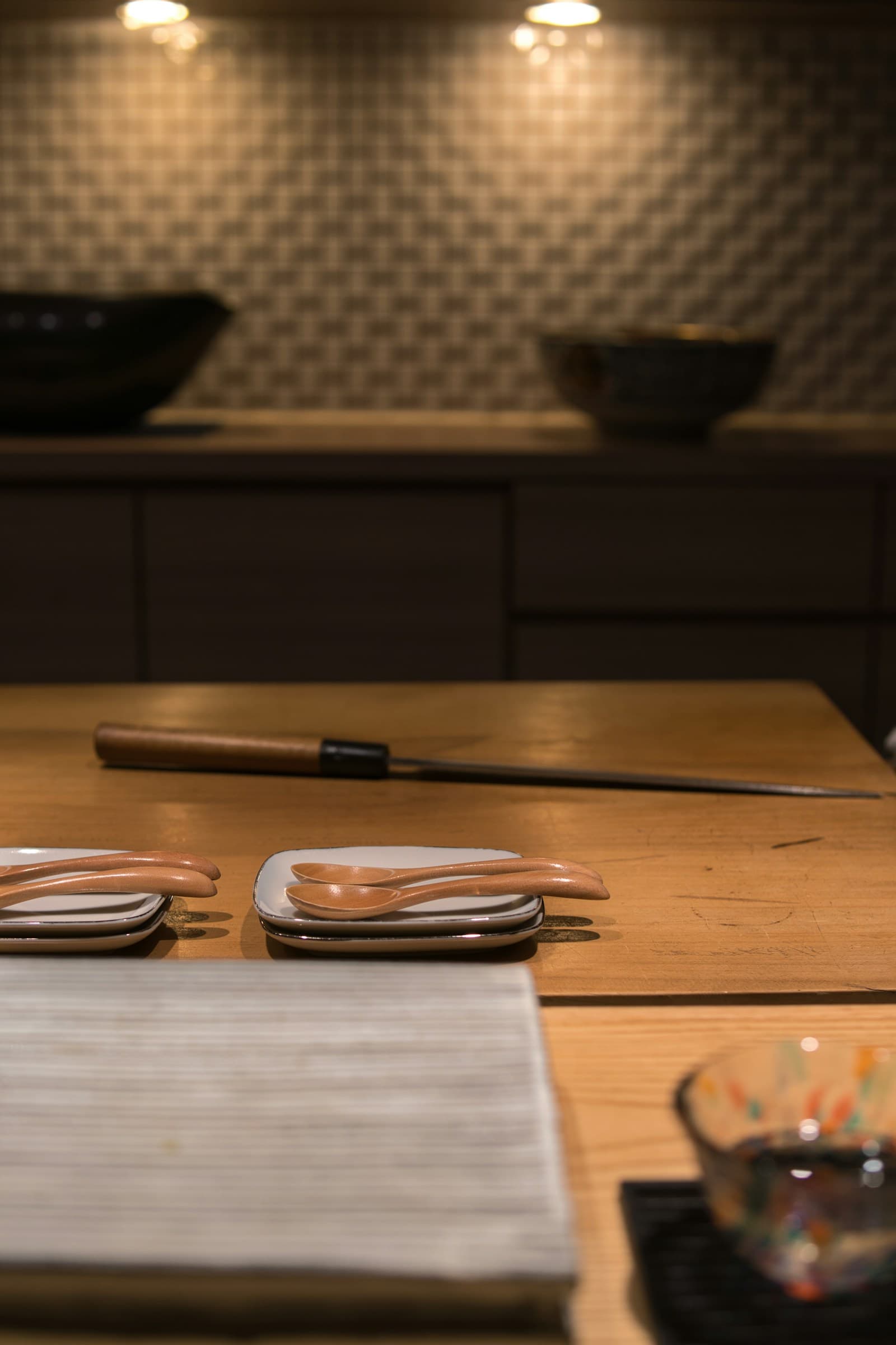Wooden counter with ceramic bowls in warm evening light